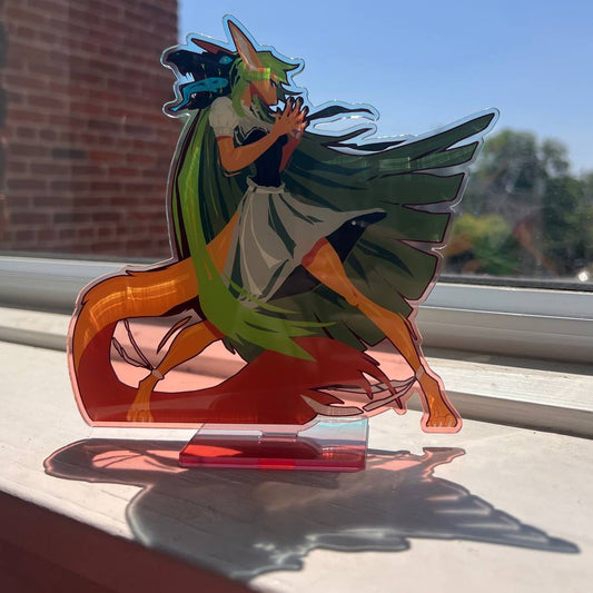 Colorful figurine of a character with animal-like features on a clear stand outdoors.