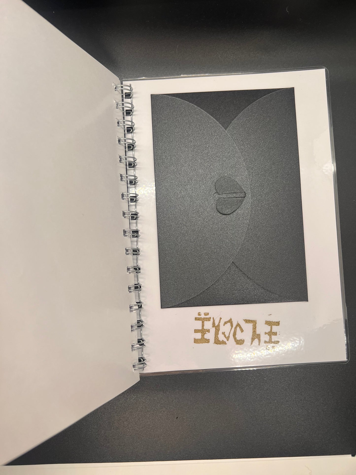 Black and white card with a heart design on a dark background