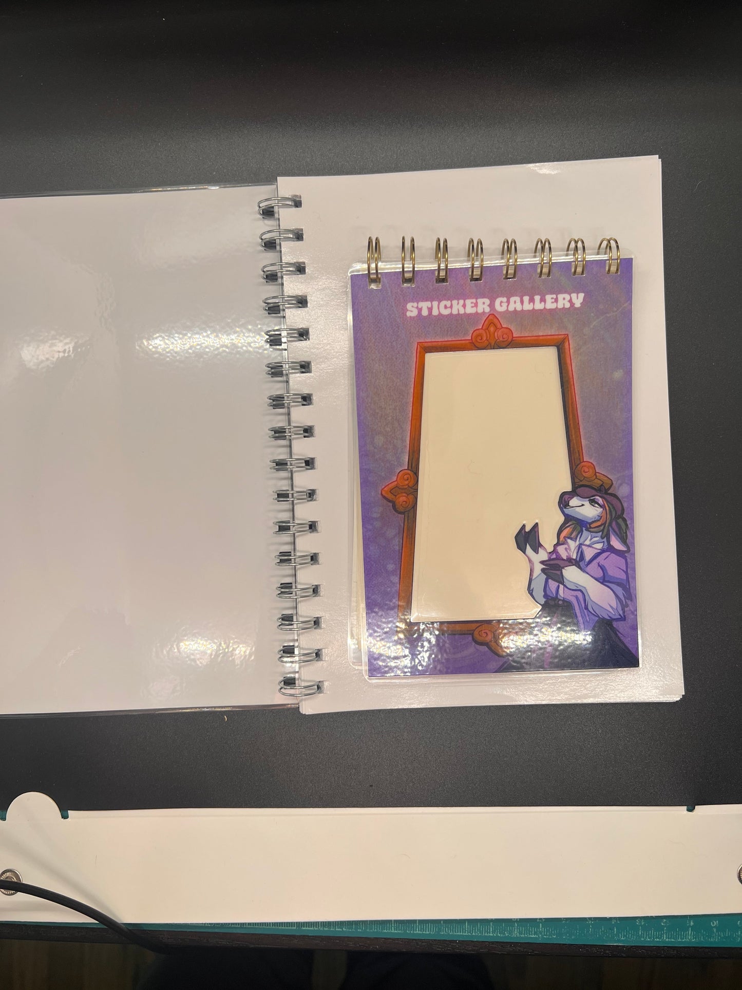 Notebook with a decorative cover featuring a character and a blank card inside.