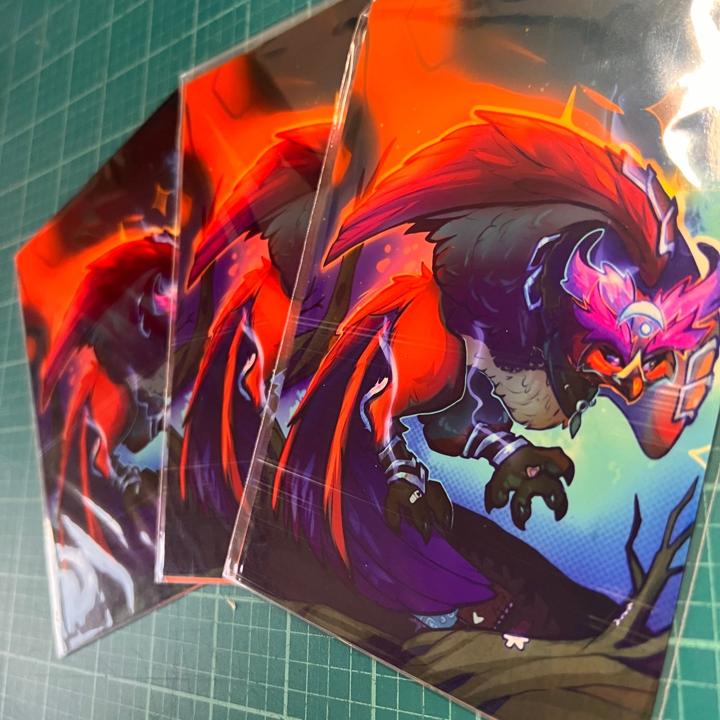 Colorful dragon illustration on a transparent sheet with a green cutting mat background